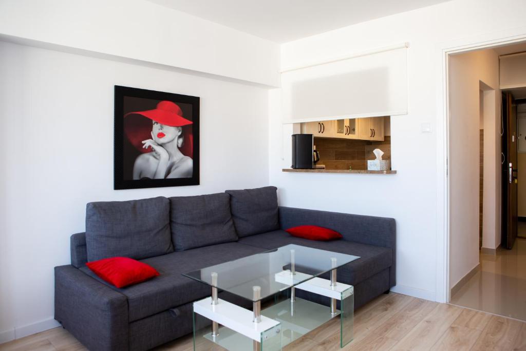 a living room with a gray couch and a glass table at bonApartments in Warsaw