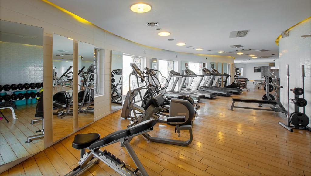 a gym with several treadmills and cardio machines at The Marmara Bodrum - Adult Only in Bodrum City
