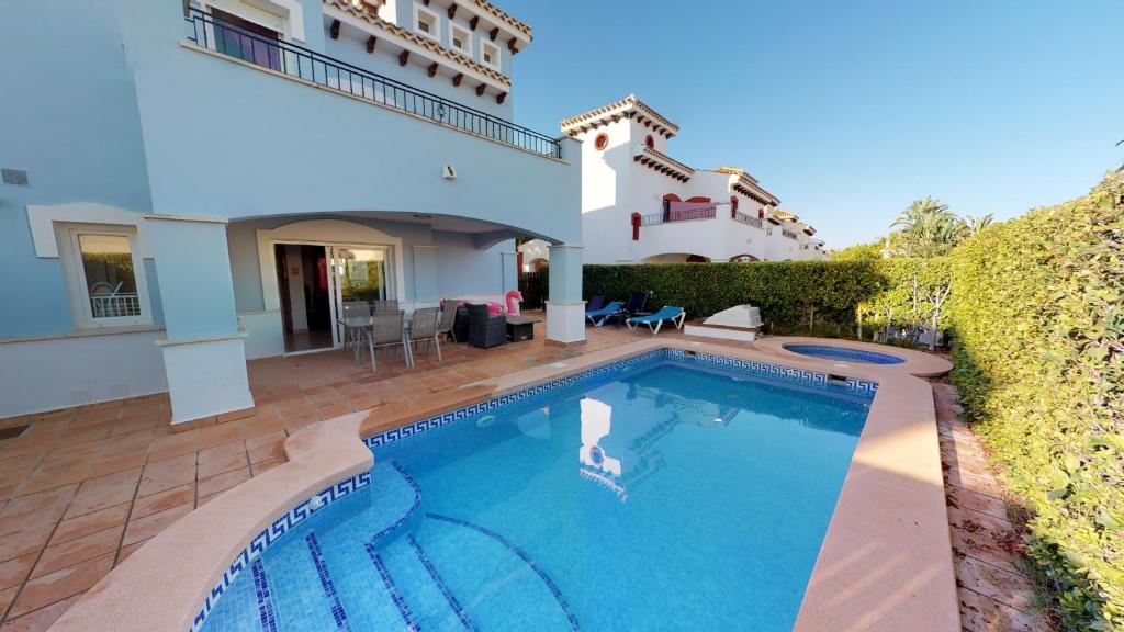 a swimming pool in front of a house at Francisco 293721-A Murcia Holiday Rentals Property in Torre-Pacheco