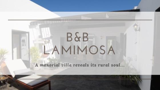 a window with a sign that says bdb lamominosa at B&B La Mimosa in Teguise