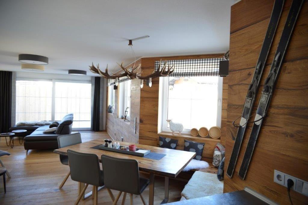 a living room with a table and a couch at Chalet Gretl in Oberstdorf