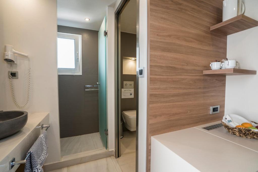 a bathroom with a sink and a toilet at Atrion Resort Hotel in Agia Marina Nea Kydonias