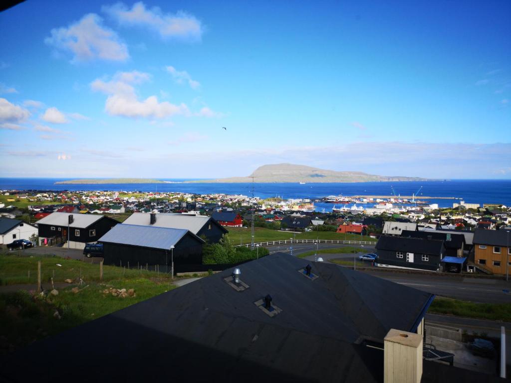 a view of a town with the ocean and buildings at Tórshavn Apartment - Great View in Tórshavn
