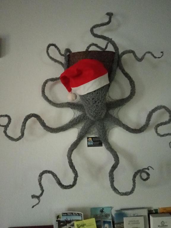 an octopus wearing a santa hat on a wall at Hostel Nature in Zambujeira do Mar