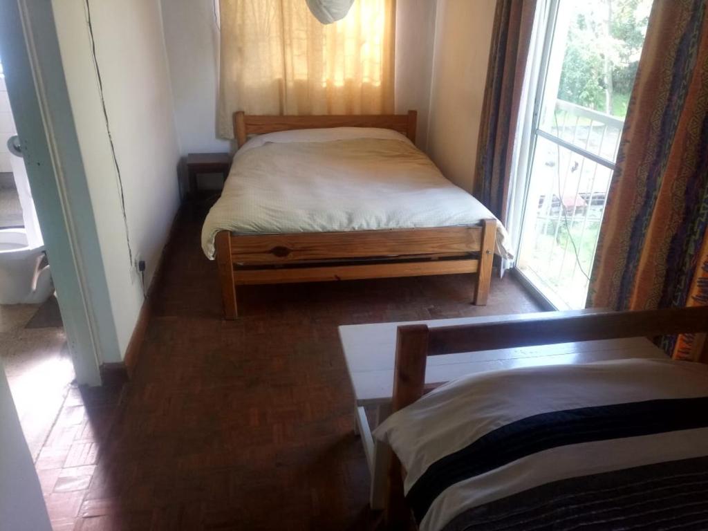 A bed or beds in a room at Karen Camp & Hostel