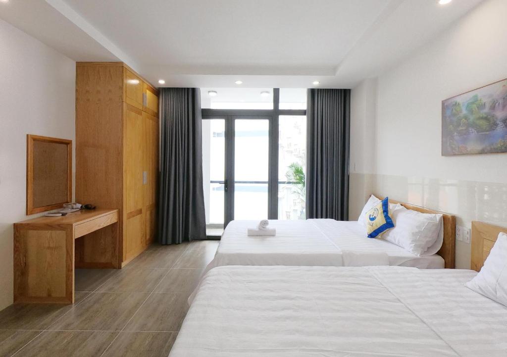 Postel nebo postele na pokoji v ubytování BaLi Motel Vung Tau