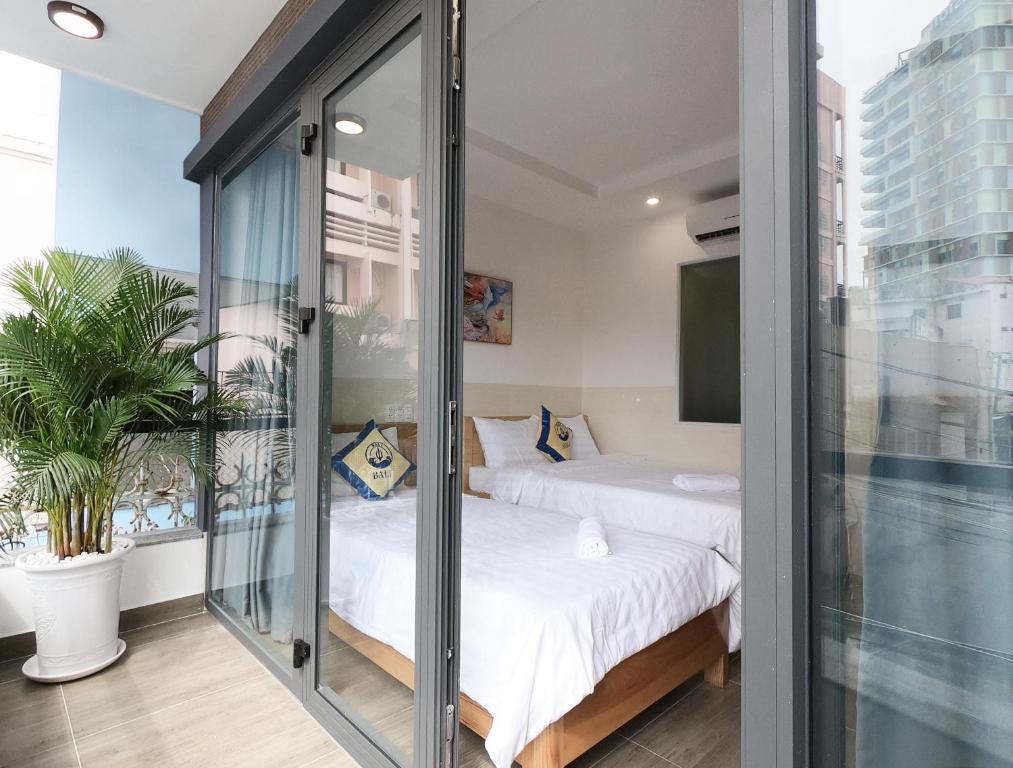 Postel nebo postele na pokoji v ubytování BaLi Motel Vung Tau
