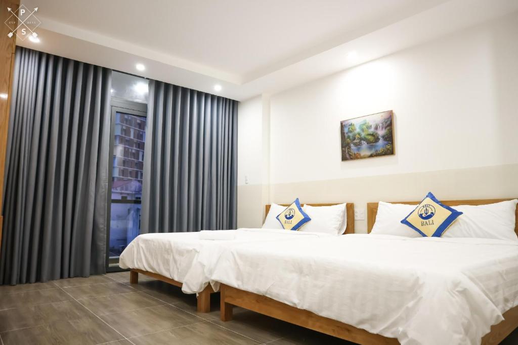 Postel nebo postele na pokoji v ubytování BaLi Motel Vung Tau