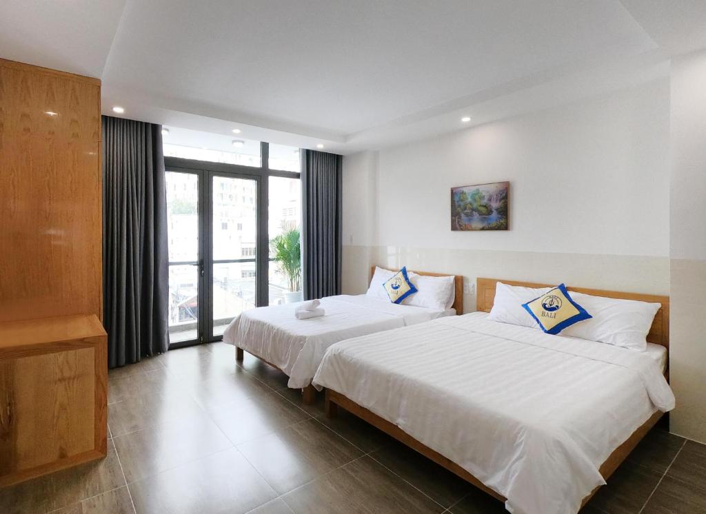 Postel nebo postele na pokoji v ubytování BaLi Motel Vung Tau