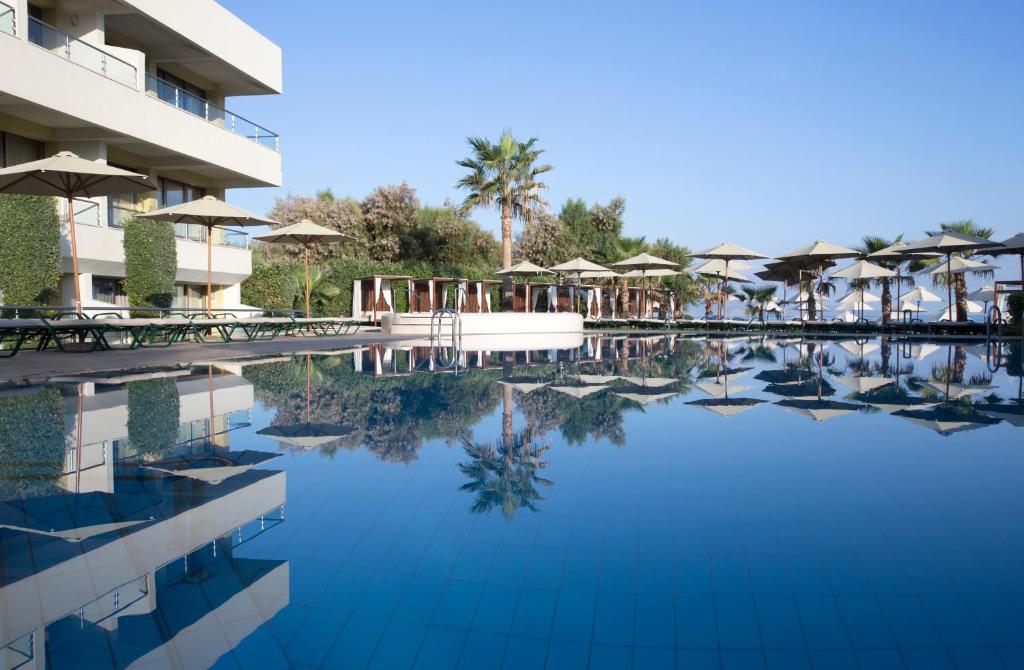 a large pool of water in front of a hotel at Thalassa Beach Resort & Spa (Adults Only) in Agia Marina Nea Kydonias