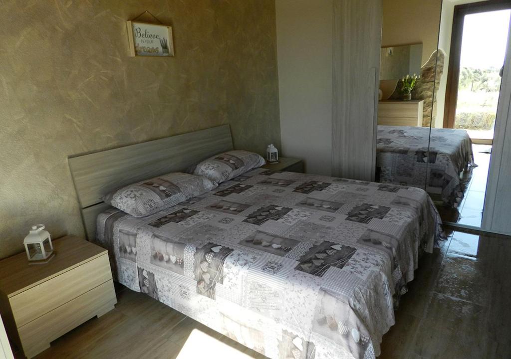 Postel nebo postele na pokoji v ubytování B&B GLI ULIVI