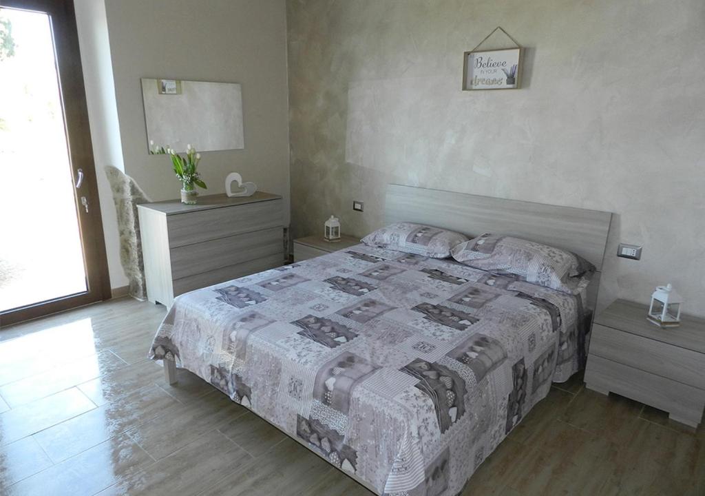 Postel nebo postele na pokoji v ubytování B&B GLI ULIVI