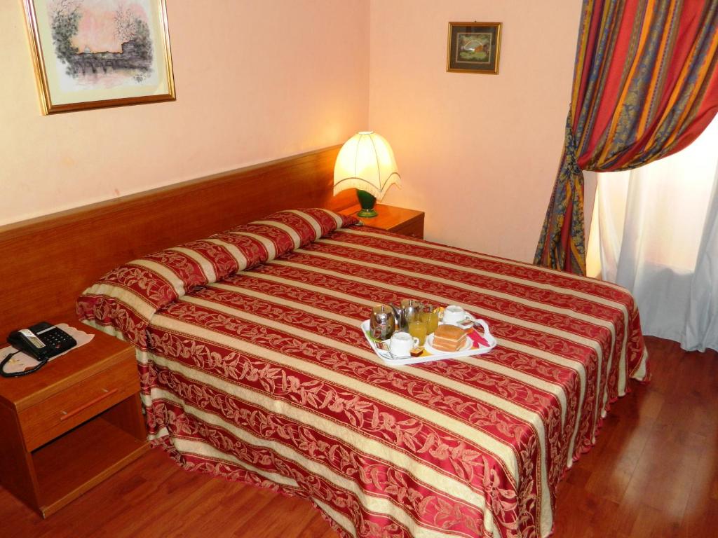 En eller flere senger på et rom på Buonarroti Home
