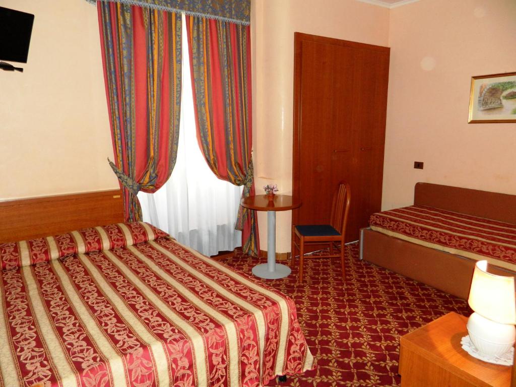 Postel nebo postele na pokoji v ubytování Buonarroti Home