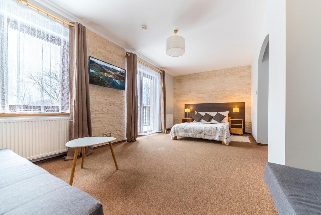 a bedroom with a bed and two windows at Nefryt - 600 m od PKP, duży parking, lodówka, czajnik, balkon, in Karpacz