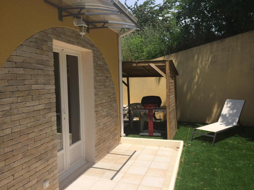 an archway leading into a backyard with a grill at Peri village in Peri