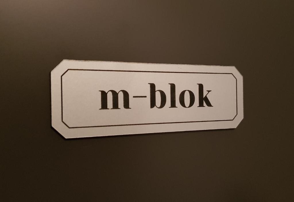 a sign that says m block on a wall at m-blok in Zagreb