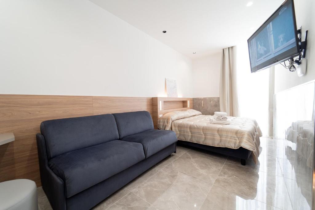 un soggiorno con divano e letto di HG Boutique Toledo, Napoli Centro, by ClaPa Group a Napoli
