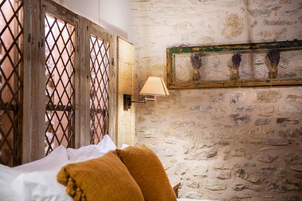 Postel nebo postele na pokoji v ubytování Borgo Antichi Orti Assisi