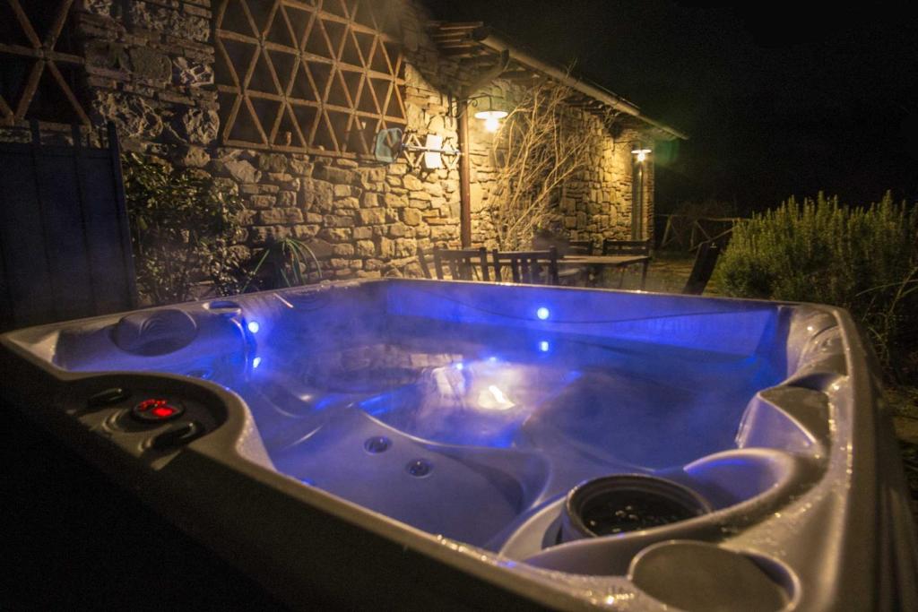 a jacuzzi tub with blue lighting in front of a building at Il Fienile del Vichiaccio in Mercatale Val Di Pesa