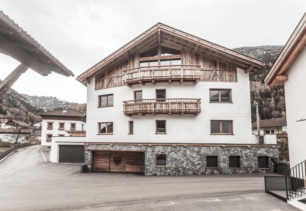 a large white building with a balcony on top of it at Chalet Nr.121 in Pfunds