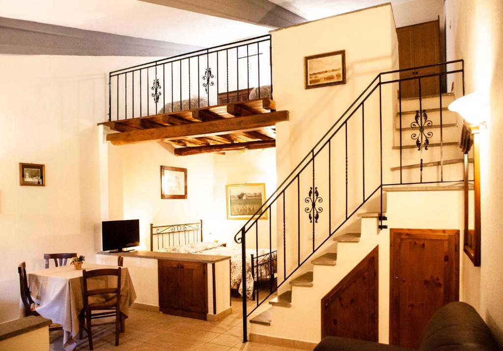 a living room with a staircase and a desk at Agriturismo Podere Giulio in Tarquinia