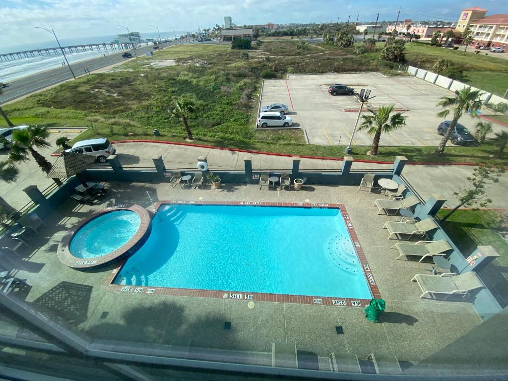 an overhead view of a swimming pool and the beach at Galveston Beach Hotel in Galveston