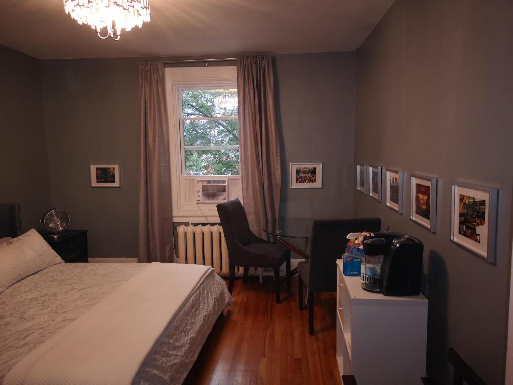 a bedroom with a bed and a desk and a window at Room with King Bed in Shared 3 Bedroom Downtown in Montréal