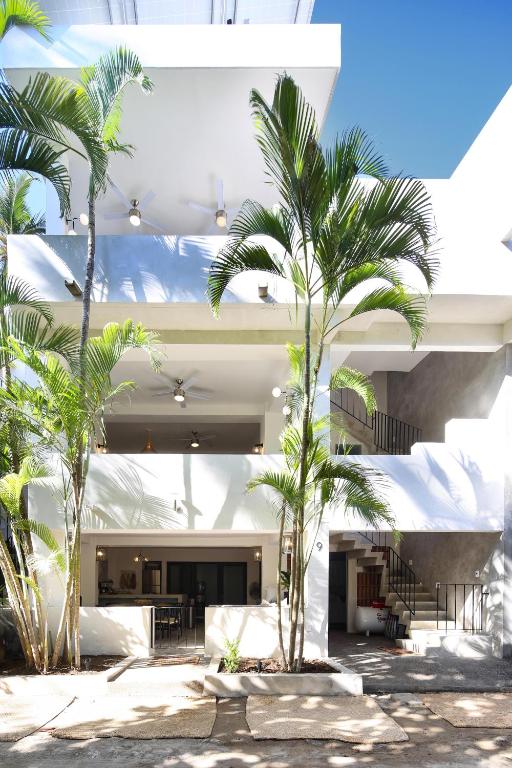 a building with palm trees in front of it at Villa Dorado - Duplex in Sayulita
