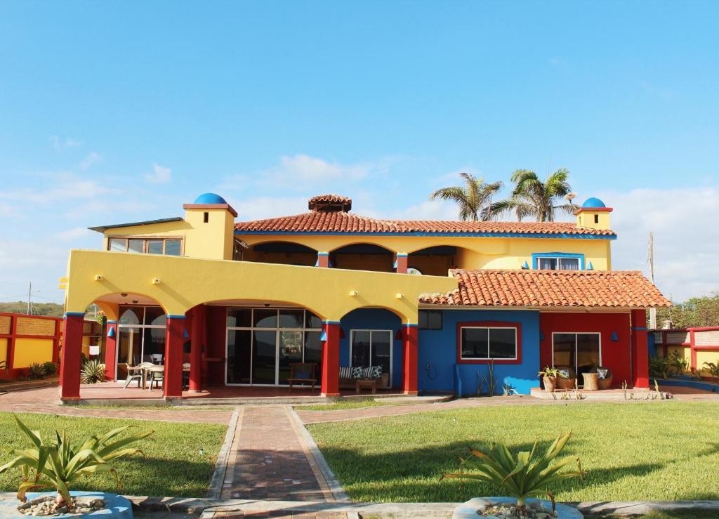 a house with a blue and yellow at Casa Amarilla in Puerto Cayo