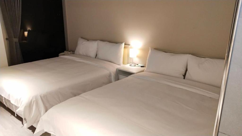 Postel nebo postele na pokoji v ubytování 駐駐逢甲 Shine Residence