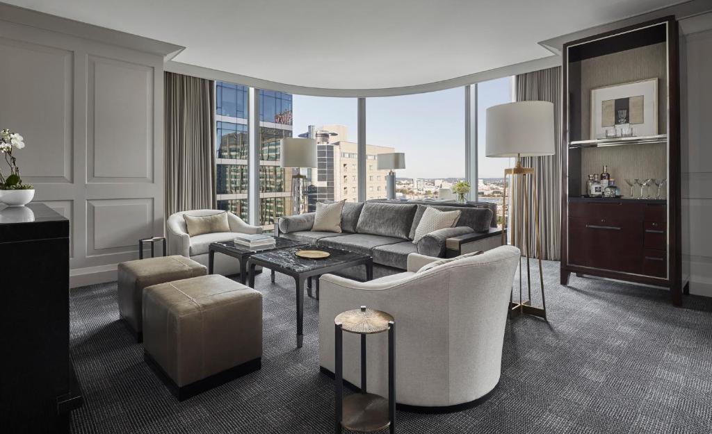 a living room with a couch and a table at Four Seasons Hotel One Dalton Street, Boston in Boston