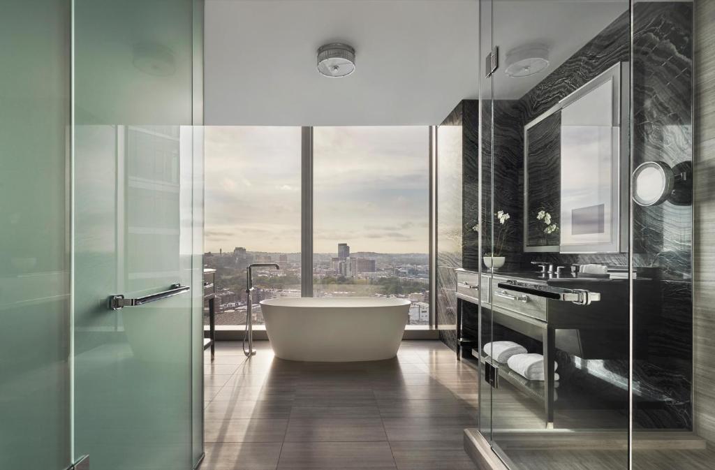 a bathroom with a tub and a large window at Four Seasons Hotel One Dalton Street, Boston in Boston