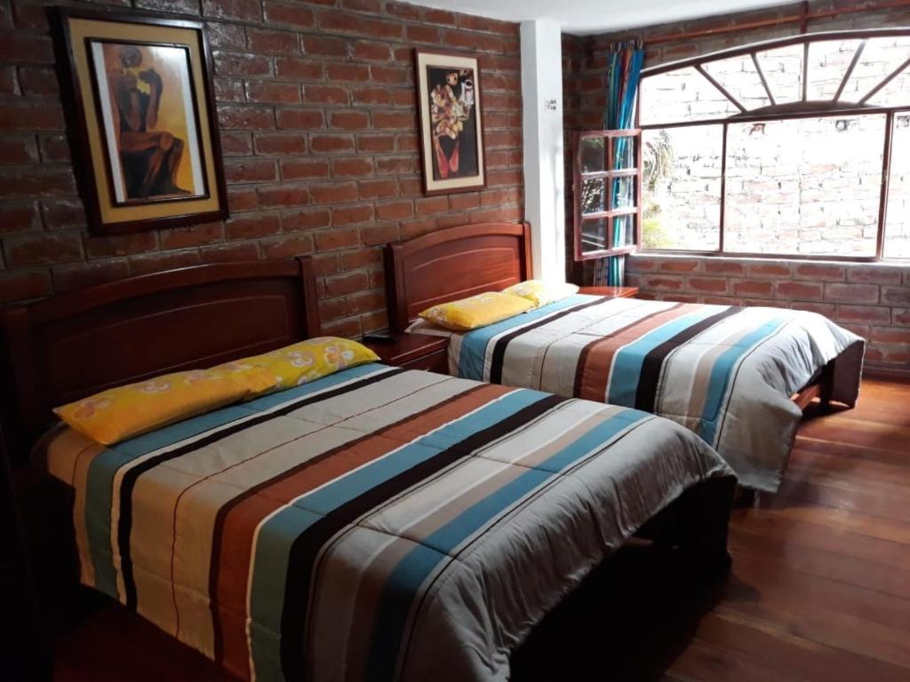 Postel nebo postele na pokoji v ubytování Hostal D´Mathias