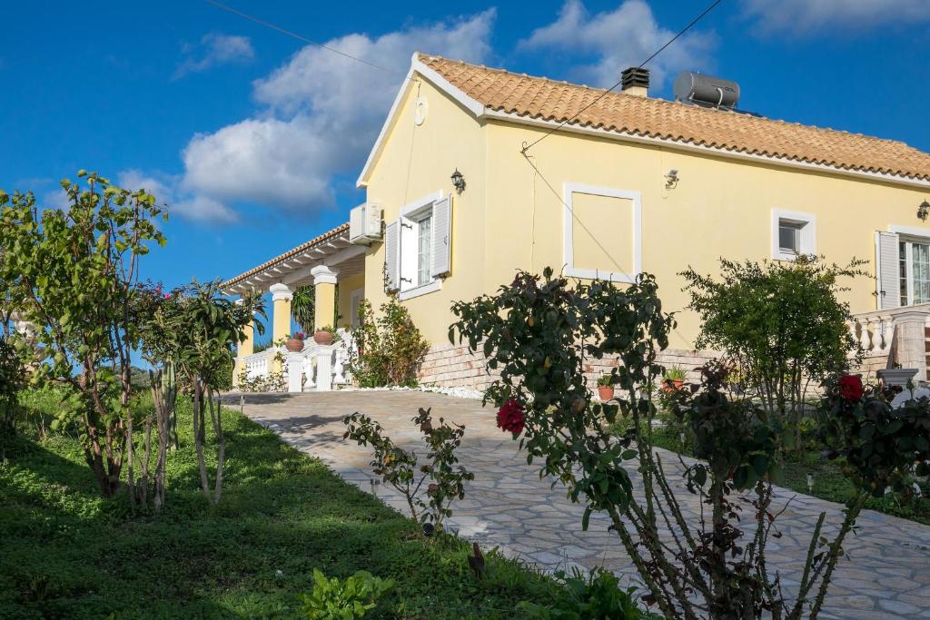 a house with a garden in front of it at Maria’s House Arillas Corfu in Arillas