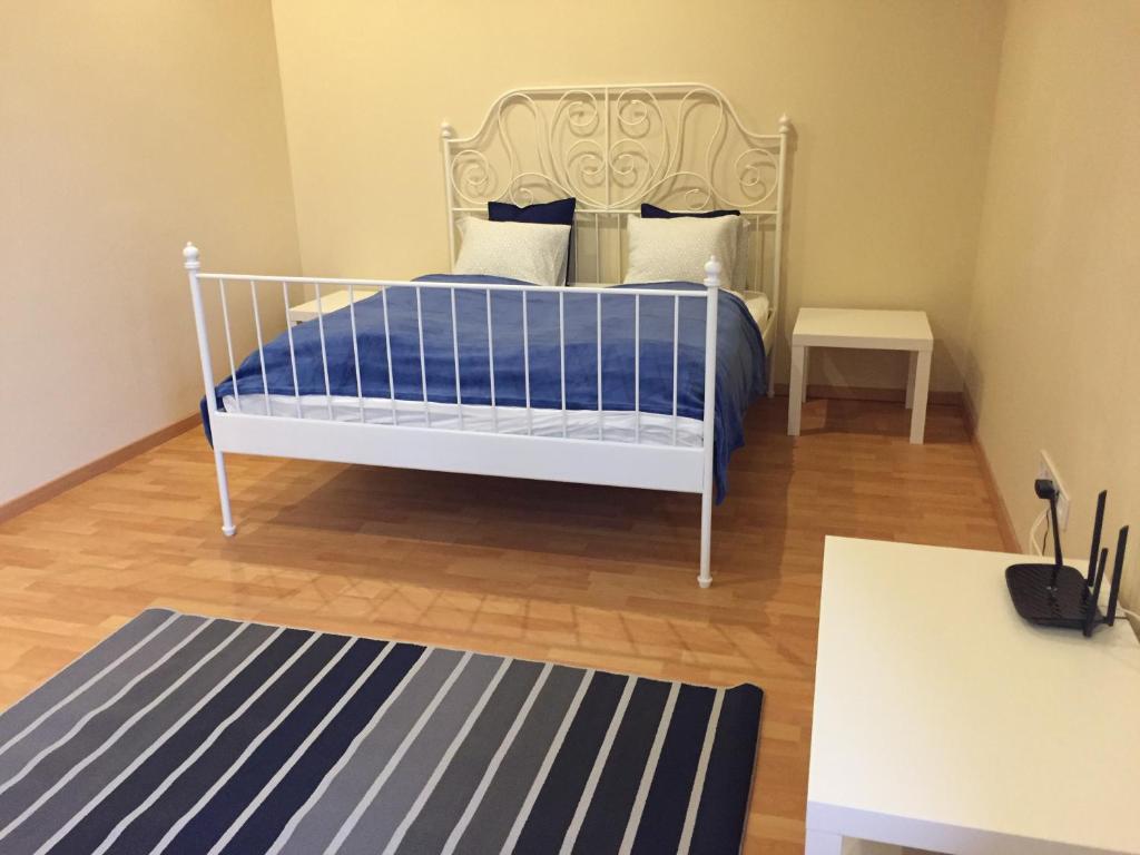 a bed sitting in a bedroom next to a wall at Budapest Airport , accommodation in Vecsés in Vecsés