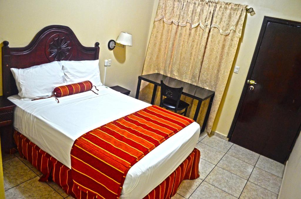 Postel nebo postele na pokoji v ubytování Hotel Plaza Palmero