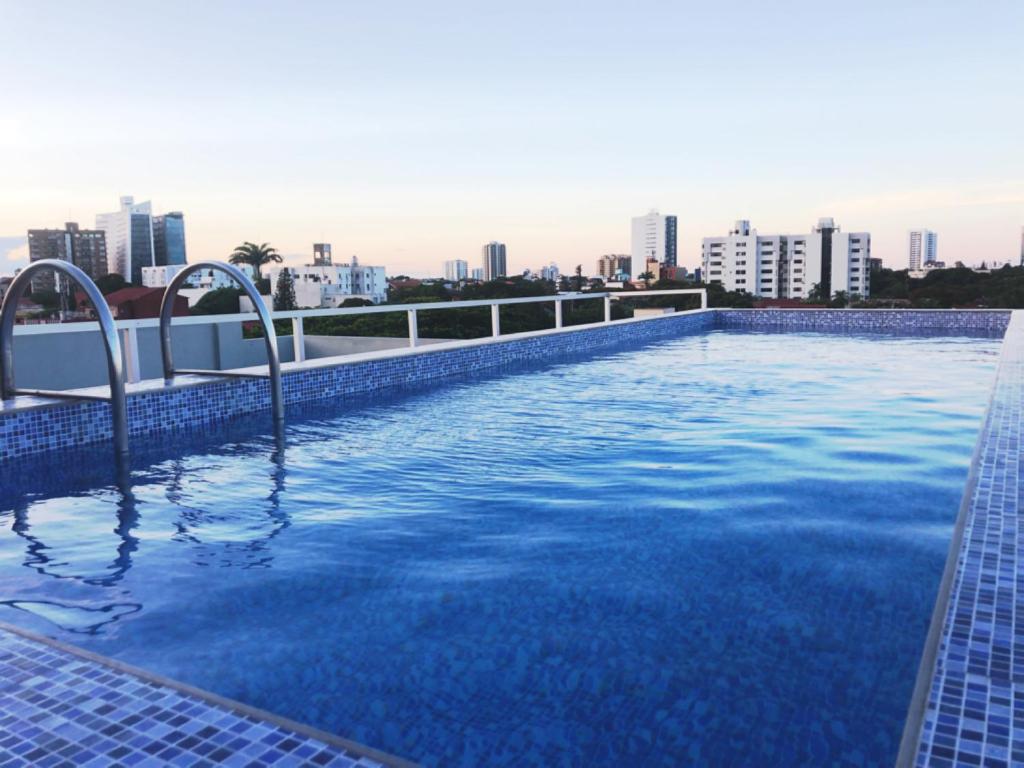 a large swimming pool with a blue sky at Pacifico Apart Hotel in Santa Cruz de la Sierra