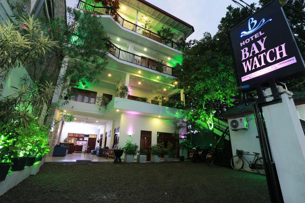 a building with a bar watch sign in front of it at Hotel Bay Watch Unawatuna in Unawatuna