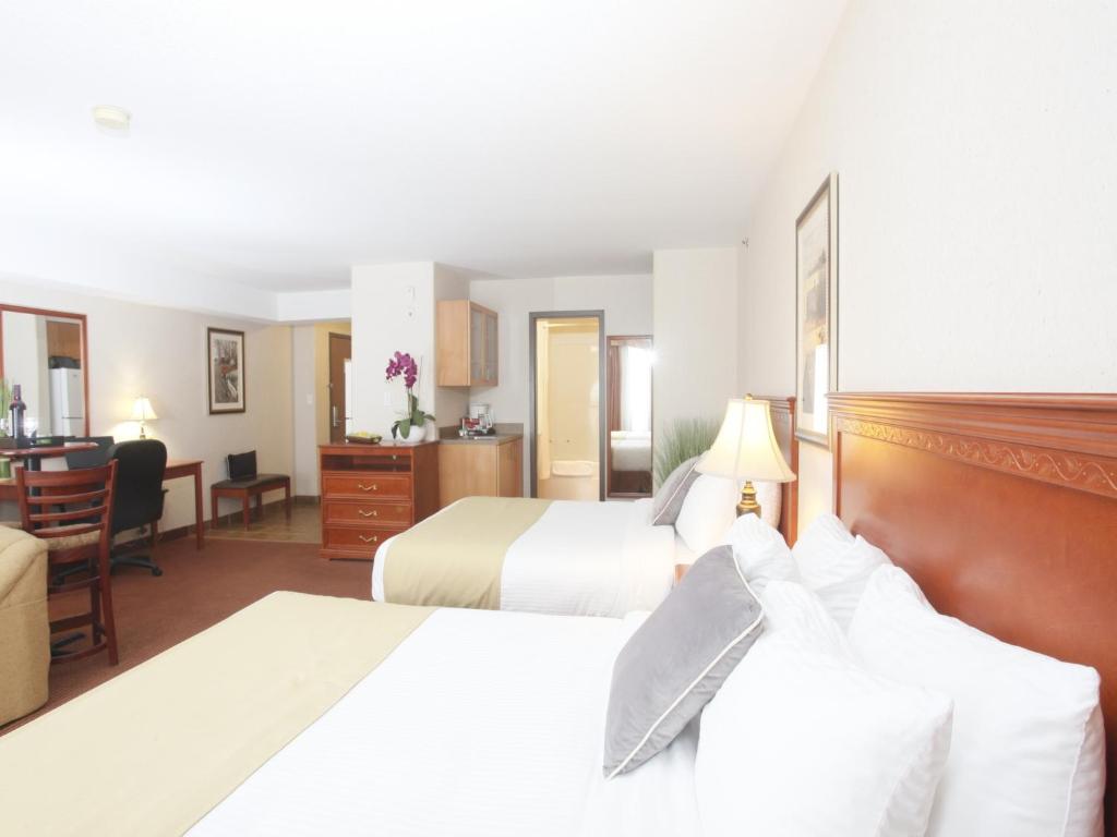 Postel nebo postele na pokoji v ubytování Stonebridge Hotel Dawson Creek