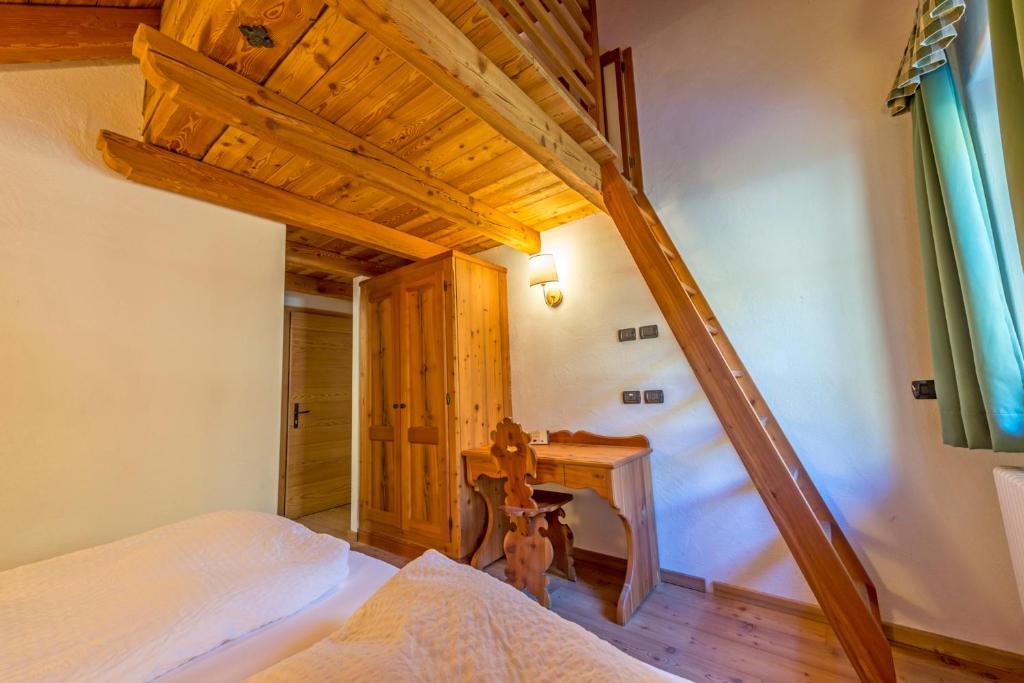 Postel nebo postele na pokoji v ubytování Rifugio Lago Nambino
