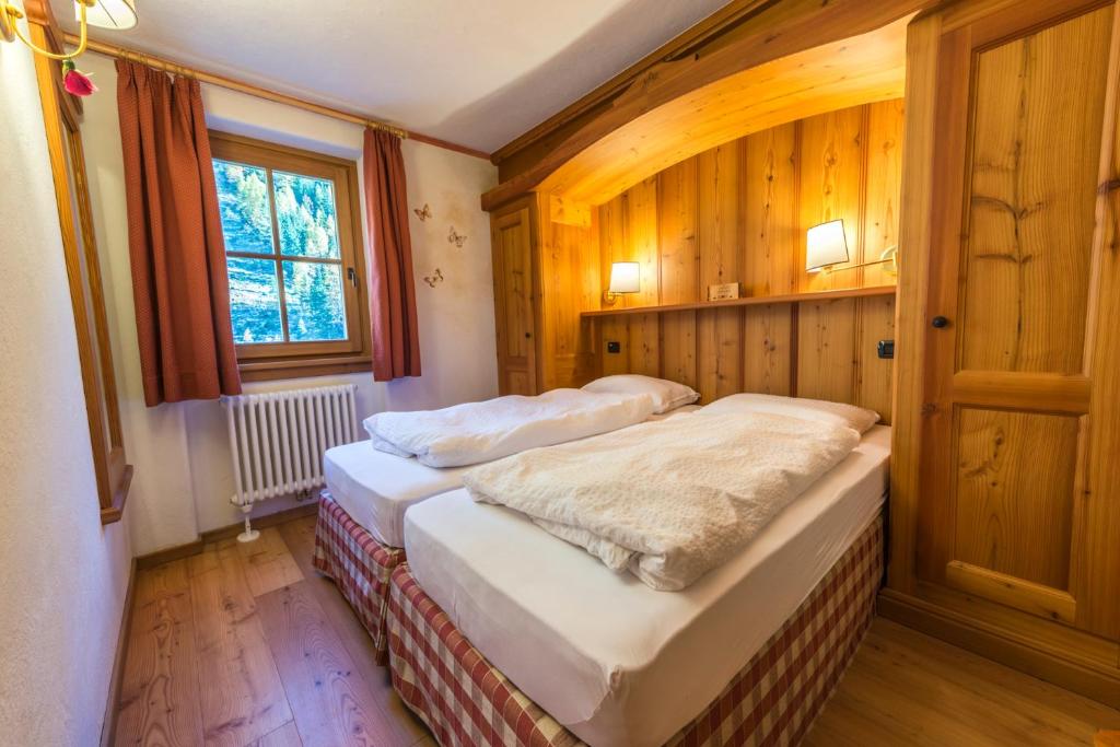 Postel nebo postele na pokoji v ubytování Rifugio Lago Nambino