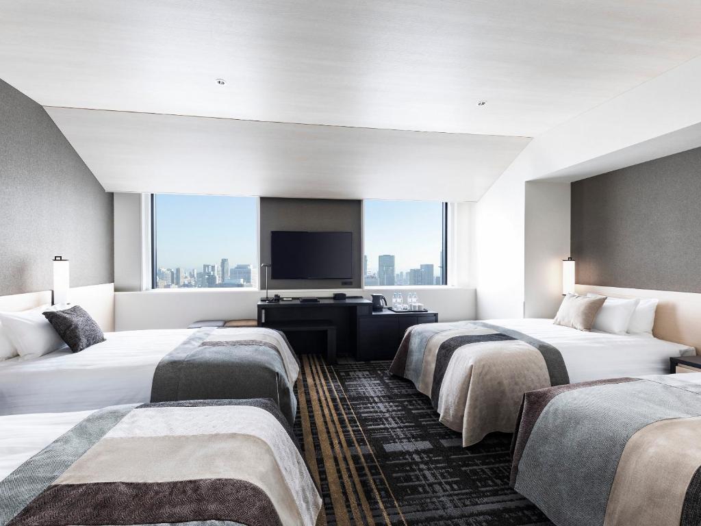 Postel nebo postele na pokoji v ubytování Hotel Hankyu RESPIRE OSAKA