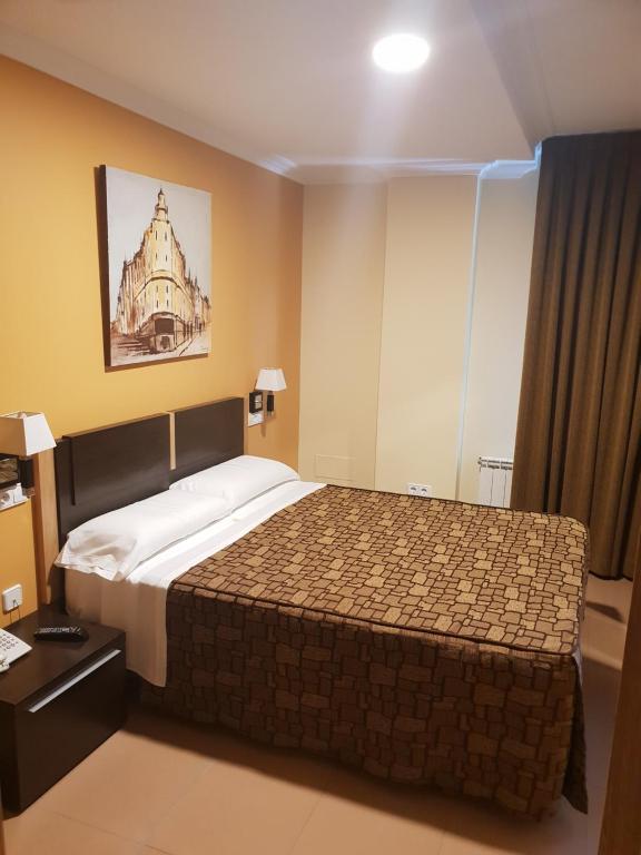 Postel nebo postele na pokoji v ubytování Hotel Reigosa