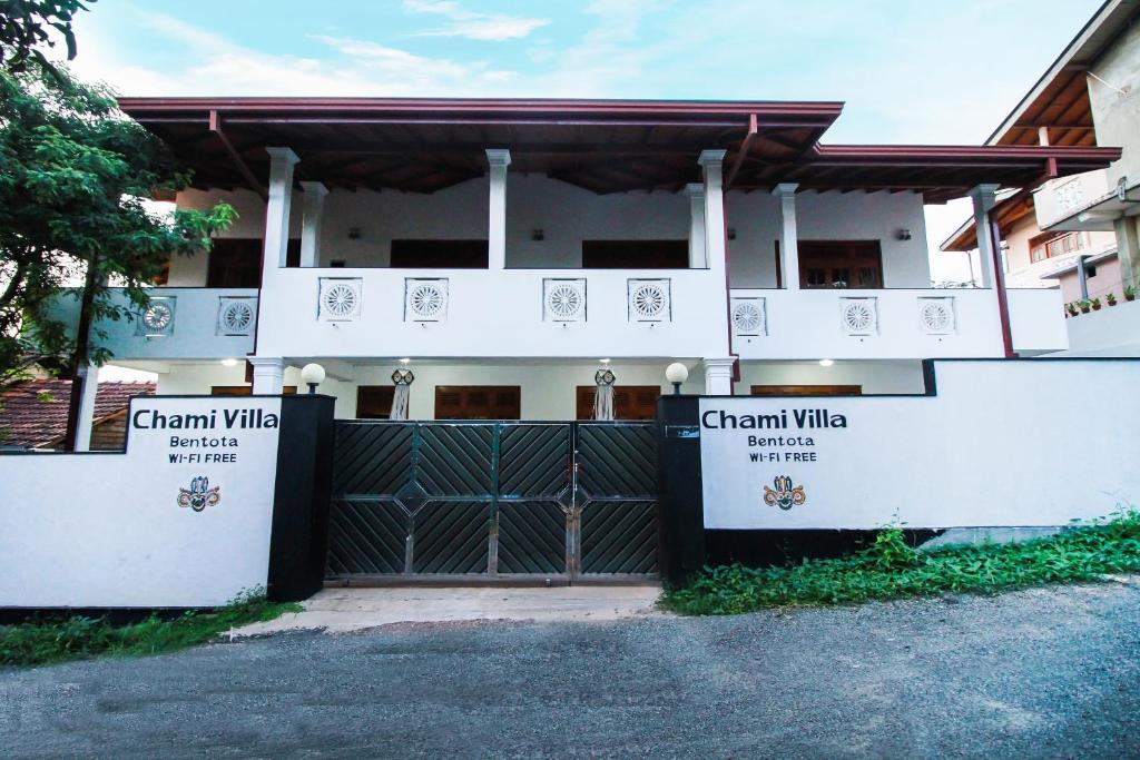 a white house with a gate with the words grant village at Chami Villa Bentota in Bentota