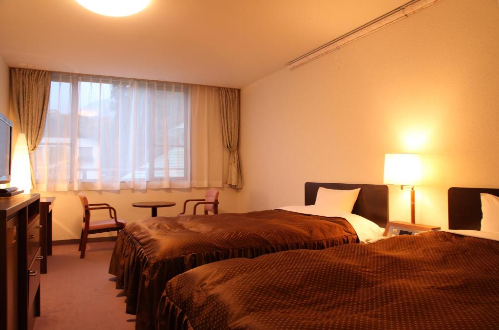 Postel nebo postele na pokoji v ubytování Hotel Oak Forest