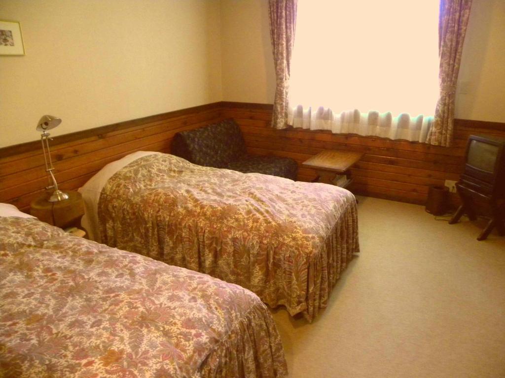 Postel nebo postele na pokoji v ubytování Petit Hotel Kazekozou