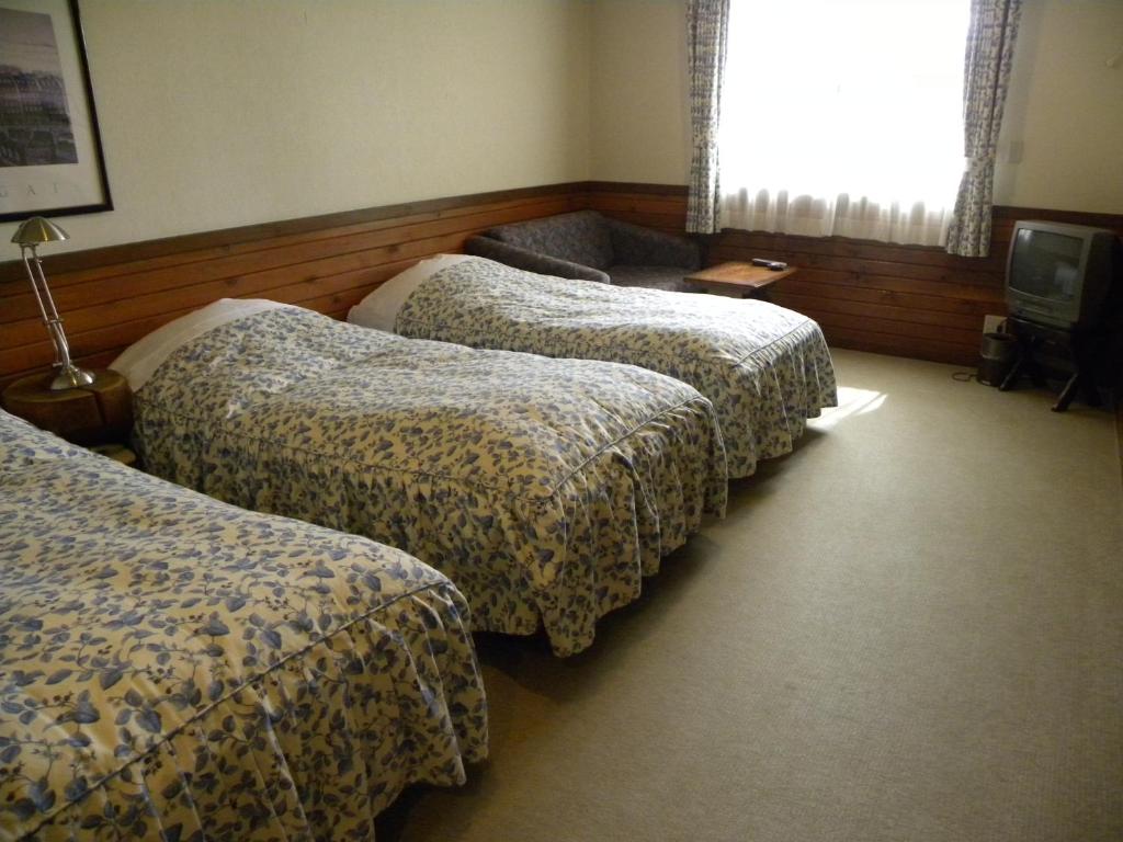 Postel nebo postele na pokoji v ubytování Petit Hotel Kazekozou