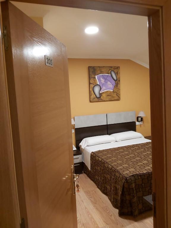 Postel nebo postele na pokoji v ubytování Hotel Reigosa