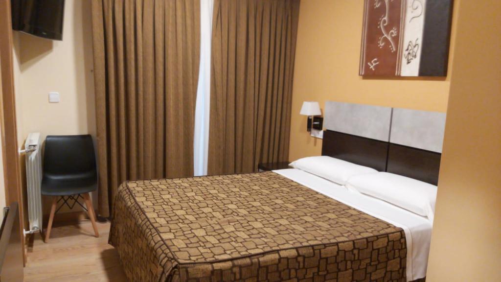 Postel nebo postele na pokoji v ubytování Hotel Reigosa